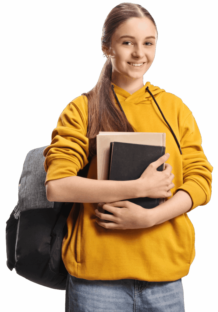 Smiling student holding books, wearing yellow hoodie.