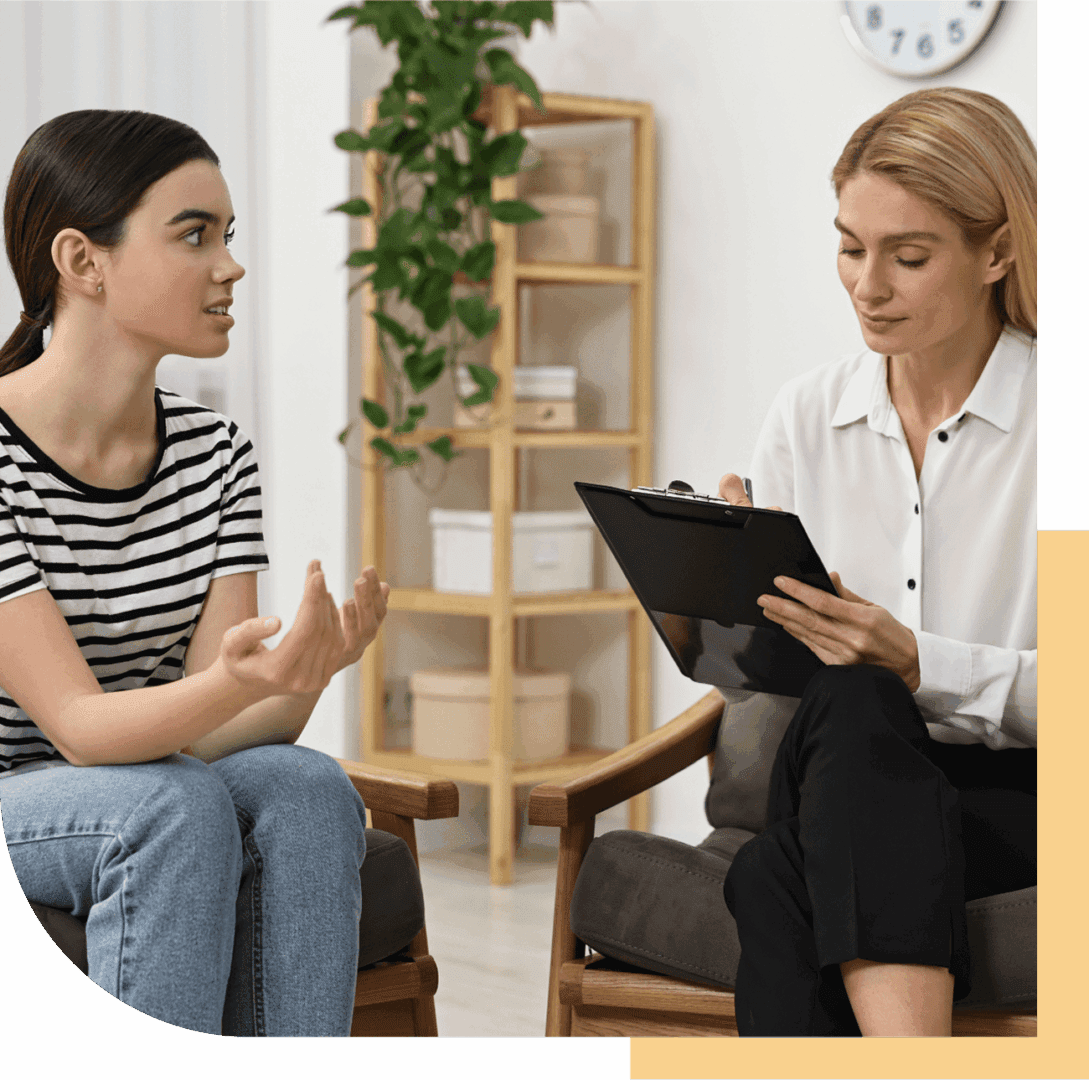 Two women talking in an office.